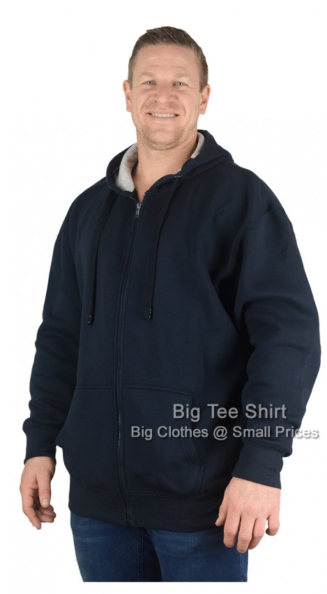 A man wearing a navy blue zip up hoodie.